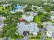 An aerial view showcasing the community with mature trees, a serene pond, and well-maintained landscaping at 1111 Golfview Woods Dr # 1111, Sun City Center, FL 33573