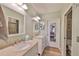 Bathroom with a double vanity, granite countertops, and a mirrored door at 1111 Golfview Woods Dr # 1111, Sun City Center, FL 33573