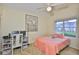 Well-lit bedroom with a ceiling fan, a desk, and a plush bed at 1111 Golfview Woods Dr # 1111, Sun City Center, FL 33573