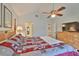 Bright bedroom featuring a ceiling fan, tv, and access to other rooms at 1111 Golfview Woods Dr # 1111, Sun City Center, FL 33573