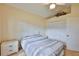 Simple bedroom featuring a bed, nightstand, and a closet with folding doors at 1111 Golfview Woods Dr # 1111, Sun City Center, FL 33573