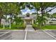 Community clubhouse with manicured lawn, mature palms, and parking at 1111 Golfview Woods Dr # 1111, Sun City Center, FL 33573