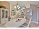 Elegant dining room with a chandelier and seamless connection to the kitchen at 1111 Golfview Woods Dr # 1111, Sun City Center, FL 33573