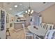 Inviting dining area featuring an oval table, chandelier, and vaulted ceiling with a skylight at 1111 Golfview Woods Dr # 1111, Sun City Center, FL 33573