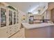 Open kitchen area with wood cabinets, bar seating, and stainless steel refrigerator at 1111 Golfview Woods Dr # 1111, Sun City Center, FL 33573