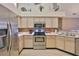 Well-lit kitchen with stainless steel appliances, modern microwave, and mosaic backsplash at 1111 Golfview Woods Dr # 1111, Sun City Center, FL 33573