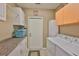 Well-organized laundry room featuring ample cabinetry, countertop space, and modern washer and dryer at 1111 Golfview Woods Dr # 1111, Sun City Center, FL 33573