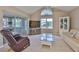 Comfortable living room with a ceiling fan, neutral walls, and sliding doors leading to patio at 1111 Golfview Woods Dr # 1111, Sun City Center, FL 33573