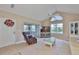 Bright living room with vaulted ceiling, neutral walls, and sliding doors leading to the patio at 1111 Golfview Woods Dr # 1111, Sun City Center, FL 33573