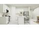Beautiful white kitchen featuring stainless steel appliances and an island with bar seating at 11729 Brae Way, Dade City, FL 33525