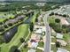 An aerial view of a single Gathering home that is near a pond on a golf course at 1224 W Del Webb Blvd, Sun City Center, FL 33573