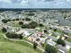 Wide aerial shot of the community, home, and golf course with ponds at 1224 W Del Webb Blvd, Sun City Center, FL 33573