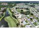 Wide aerial shot of the community, home, and golf course with ponds at 1224 W Del Webb Blvd, Sun City Center, FL 33573