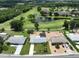 An aerial view of a single Gathering home that is near a pond on a golf course at 1224 W Del Webb Blvd, Sun City Center, FL 33573