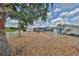 Spacious backyard with a screen-enclosed pool, garden, and seating area overlooking the community with lush landscaping at 1224 W Del Webb Blvd, Sun City Center, FL 33573