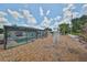 Spacious backyard with screen-enclosed pool, outdoor seating, garden and an arbor near the scenic community views at 1224 W Del Webb Blvd, Sun City Center, FL 33573