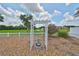 Landscaped backyard with white arbor and fountain featuring community views with a golf course and pond in the distance at 1224 W Del Webb Blvd, Sun City Center, FL 33573