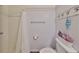 Cozy bathroom with a white shower curtain, white wainscoting, and convenient towel racks at 1224 W Del Webb Blvd, Sun City Center, FL 33573