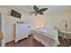 Cozy bedroom with wood look floors, ceiling fan, and a window for natural light at 1224 W Del Webb Blvd, Sun City Center, FL 33573