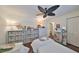 Comfortable bedroom with neutral tones, a ceiling fan, and an organized closet space at 1224 W Del Webb Blvd, Sun City Center, FL 33573