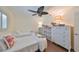 Inviting bedroom with twin beds, wooden-look floors, and a large ceiling fan at 1224 W Del Webb Blvd, Sun City Center, FL 33573