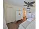 Bedroom featuring wood look floors, large closet, and ceiling fan at 1224 W Del Webb Blvd, Sun City Center, FL 33573