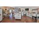 Multi-functional room with office setup, couch, hardwood floors, and ample storage space at 1224 W Del Webb Blvd, Sun City Center, FL 33573