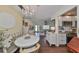 Charming dining area with chandelier, hardwood floors, and white furniture, connecting to the kitchen and living room at 1224 W Del Webb Blvd, Sun City Center, FL 33573