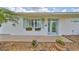 Inviting front entrance with colorful flowers accenting the turquoise door and shutters, creating a cheerful curb appeal at 1224 W Del Webb Blvd, Sun City Center, FL 33573