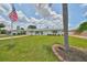 Beautiful single-story home with a well-maintained lawn, palm trees and a sidewalk at 1224 W Del Webb Blvd, Sun City Center, FL 33573