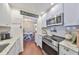 Well-lit kitchen with white cabinets, stainless steel appliances, and granite counters at 1224 W Del Webb Blvd, Sun City Center, FL 33573