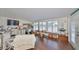 Bright living room with wood floors, white trim, and view of the outdoors at 1224 W Del Webb Blvd, Sun City Center, FL 33573