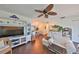 Open-concept living room with hardwood floors, entertainment center, and comfortable seating at 1224 W Del Webb Blvd, Sun City Center, FL 33573