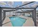 Screened in pool with bright blue water, integrated steps, and an outdoor lounge area for relaxing and entertaining at 1224 W Del Webb Blvd, Sun City Center, FL 33573