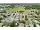 Aerial view showcasing the neighborhood with mature trees, residential streets, and a view of neighborhood baseball fields at 12306 91St Ter, Seminole, FL 33772
