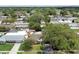 Overhead view of a home in a verdant neighborhood, featuring a well-manicured lawn and mature trees at 12306 91St Ter, Seminole, FL 33772