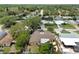 Lovely aerial view showcasing a charming neighborhood with lush green trees and well-maintained homes at 12306 91St Ter, Seminole, FL 33772