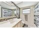 Well-lit bathroom featuring a modern vanity, mirror, and a shower with a stylish shower curtain at 12306 91St Ter, Seminole, FL 33772