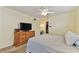 Inviting bedroom featuring a comfortable bed, natural light, and a wooden dresser at 12306 91St Ter, Seminole, FL 33772