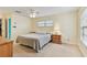 Comfortable bedroom with neutral walls, a ceiling fan, and natural light from the window at 12306 91St Ter, Seminole, FL 33772