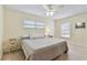 Inviting bedroom featuring a comfortable bed, natural light, and neutral decor at 12306 91St Ter, Seminole, FL 33772