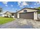 Attractive home exterior featuring a basketball hoop above the two-car garage at 12306 91St Ter, Seminole, FL 33772
