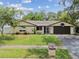 Charming single-story home with a well-maintained lawn and a two-car garage at 12306 91St Ter, Seminole, FL 33772