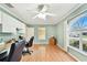 Bright home office with natural light, built-in desk, and wood laminate flooring at 12306 91St Ter, Seminole, FL 33772