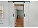 Stylish barn doors open to reveal a room with hardwood floors and classic decor at 12306 91St Ter, Seminole, FL 33772