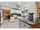 A well-lit kitchen with white cabinets, black countertops and backsplash, and stainless steel appliances at 12306 91St Ter, Seminole, FL 33772