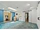 Bright living room with a comfortable chair and barn-style sliding doors at 12306 91St Ter, Seminole, FL 33772