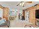 Cozy living room with wood paneling, an adjacent dining area, and an open view of the modern kitchen at 12306 91St Ter, Seminole, FL 33772
