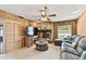 The living room features wood walls, a stone fireplace, and comfortable seating at 12306 91St Ter, Seminole, FL 33772