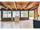 Inviting sunroom with a wood-paneled ceiling, tiled floor, and bright windows offering views of the backyard at 12306 91St Ter, Seminole, FL 33772